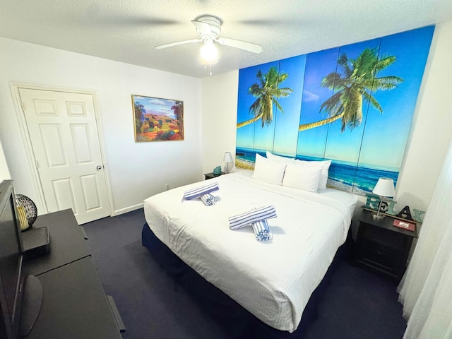 bedroom featuring a textured ceiling, dark colored carpet, ceiling fan, and baseboards