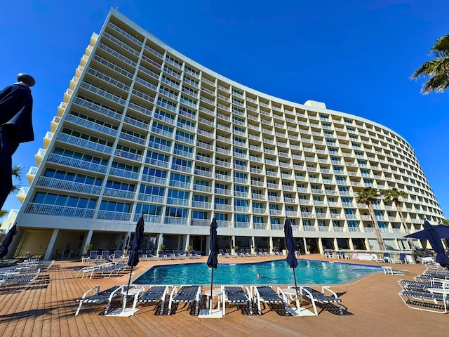 view of building exterior featuring a community pool