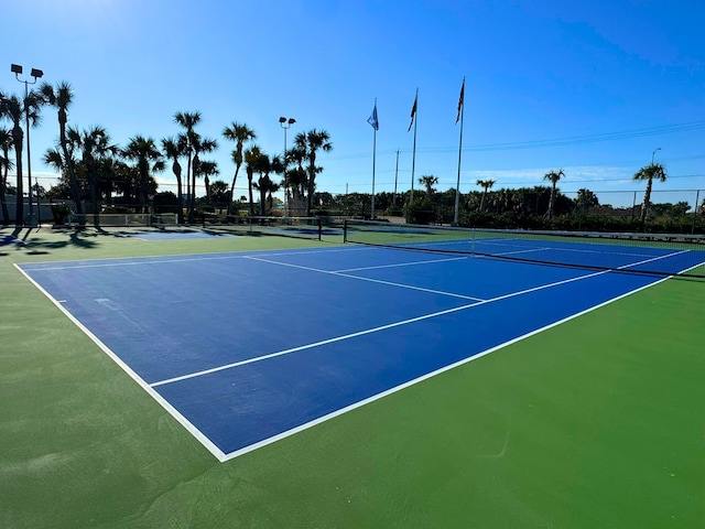 view of tennis court featuring fence