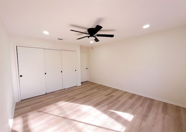 unfurnished bedroom with light wood finished floors, visible vents, recessed lighting, and a closet