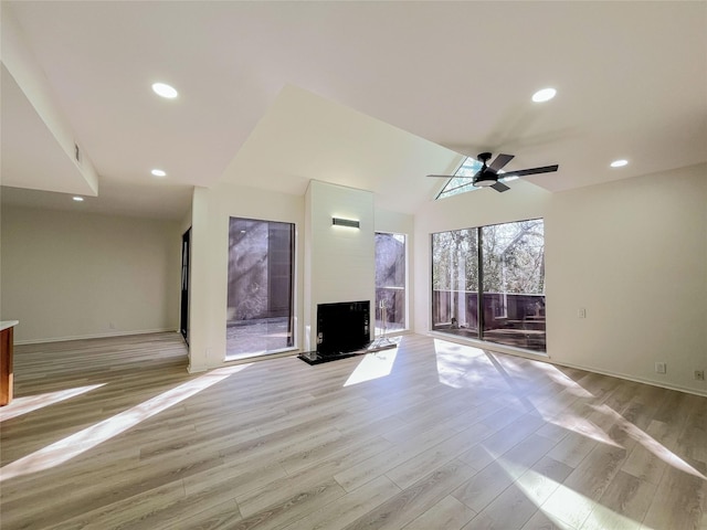 unfurnished living room featuring lofted ceiling, recessed lighting, light wood-style floors, baseboards, and ceiling fan