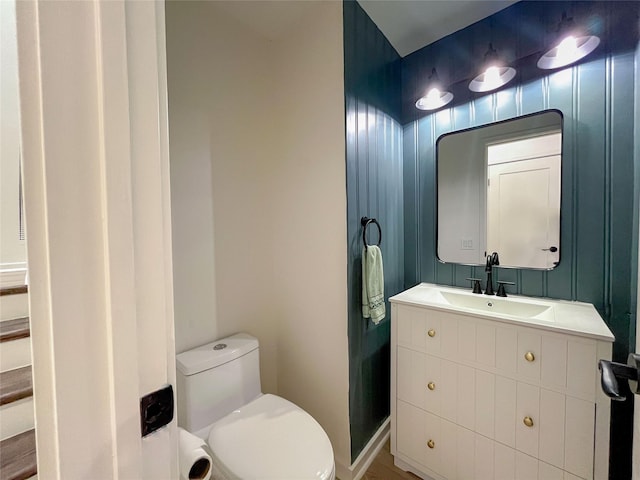 half bathroom with vanity and toilet