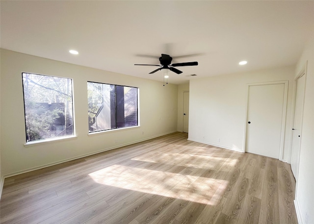 unfurnished room with recessed lighting, baseboards, and light wood finished floors