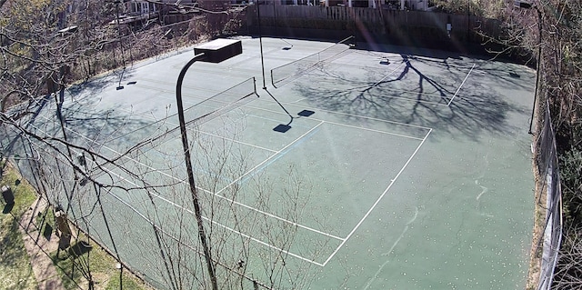 view of tennis court featuring fence