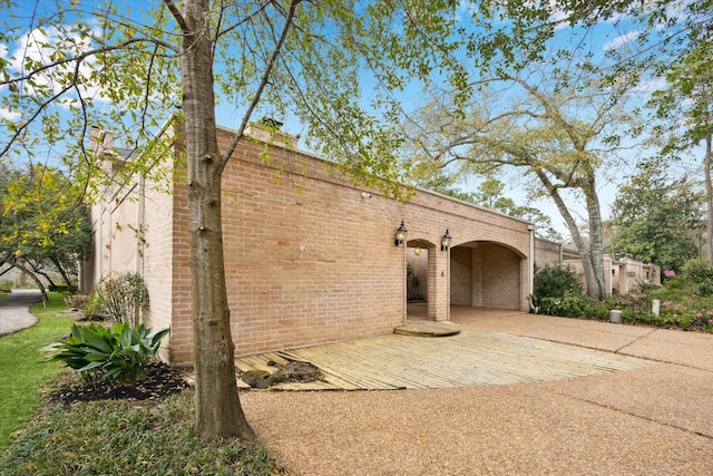 view of property exterior with brick siding