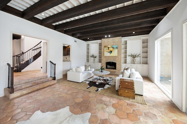 living area with stairs, beamed ceiling, built in shelves, and a fireplace