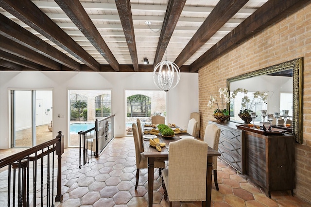 dining area with beam ceiling, brick wall, and a chandelier