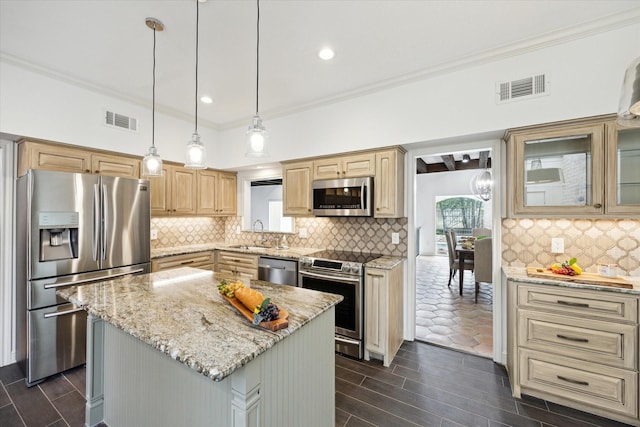 kitchen featuring light stone counters, visible vents, appliances with stainless steel finishes, and a center island