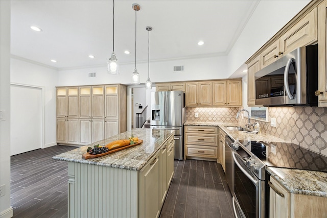 kitchen featuring visible vents, light brown cabinets, stainless steel appliances, and ornamental molding