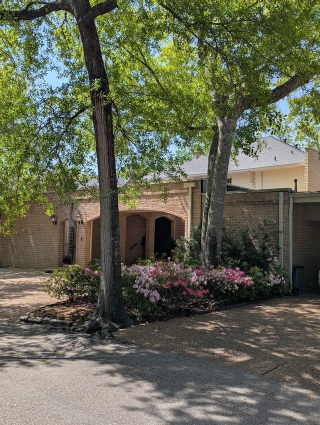 view of front of property with brick siding and fence