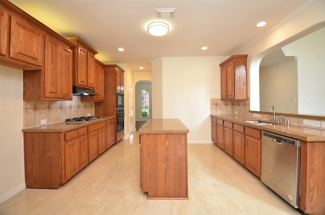 kitchen with visible vents, arched walkways, a center island, black appliances, and a sink