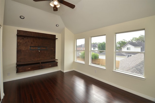 unfurnished living room with lofted ceiling, wood finished floors, a ceiling fan, and baseboards