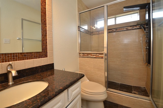 full bath featuring toilet, a shower stall, backsplash, and vanity