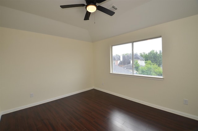 empty room with baseboards, visible vents, a ceiling fan, lofted ceiling, and wood finished floors