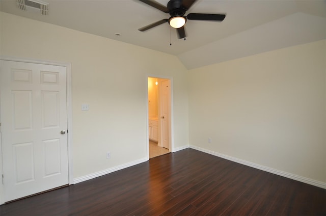 interior space featuring a ceiling fan, visible vents, vaulted ceiling, baseboards, and dark wood-style floors