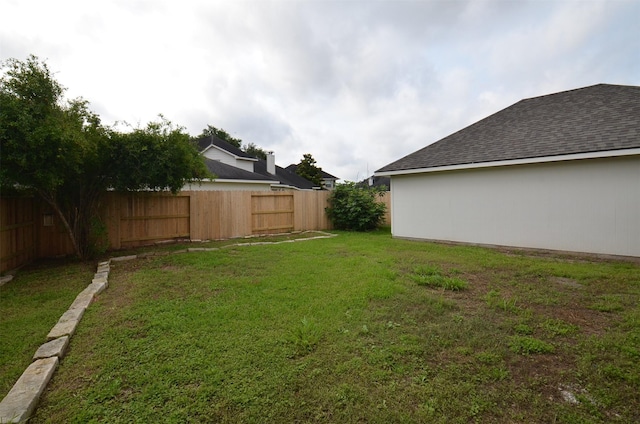 view of yard with a fenced backyard