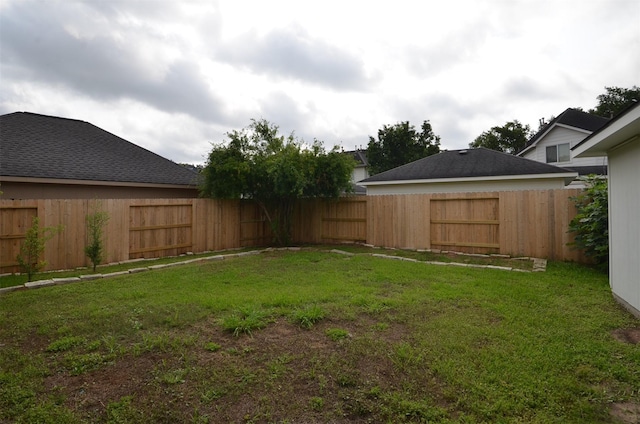 view of yard with a fenced backyard