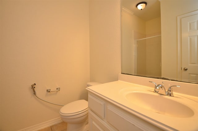 bathroom with baseboards, toilet, a shower with door, tile patterned flooring, and vanity