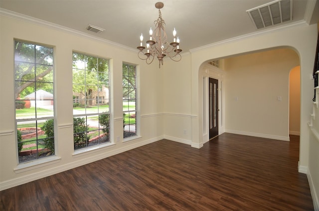 unfurnished room with visible vents, arched walkways, and dark wood-type flooring