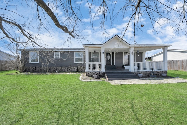 view of front of property with fence, a front lawn, and a porch