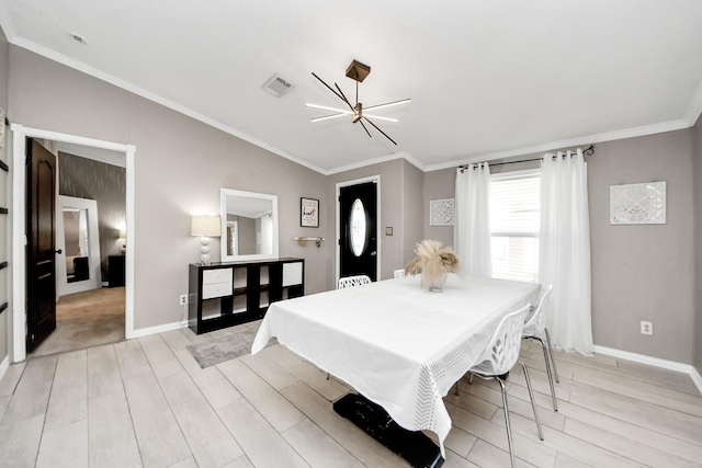 bedroom featuring light wood finished floors, baseboards, vaulted ceiling, and crown molding