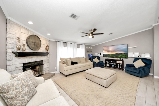 living area featuring lofted ceiling, visible vents, and ornamental molding