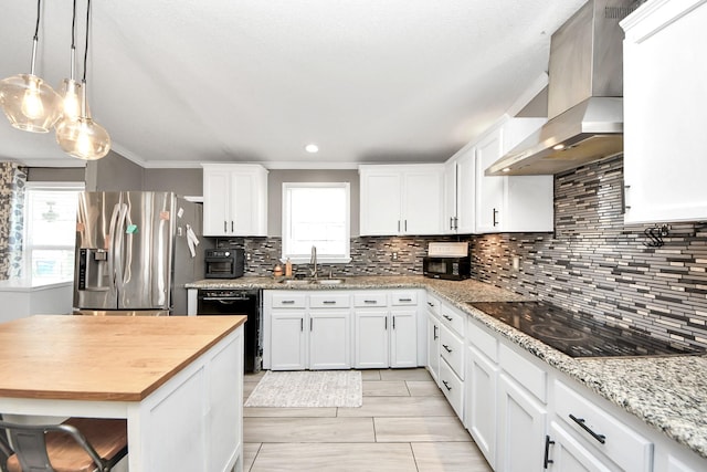 kitchen featuring wall chimney exhaust hood, black appliances, white cabinetry, wooden counters, and a sink