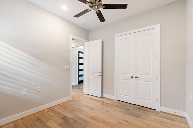 unfurnished bedroom with light wood-style floors, baseboards, a closet, and ceiling fan