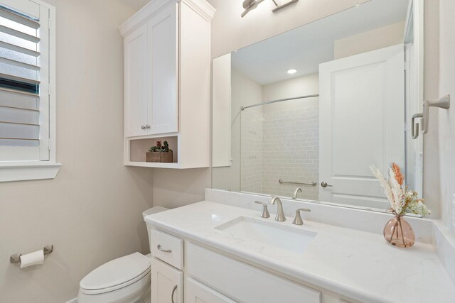 bathroom with vanity, toilet, and walk in shower