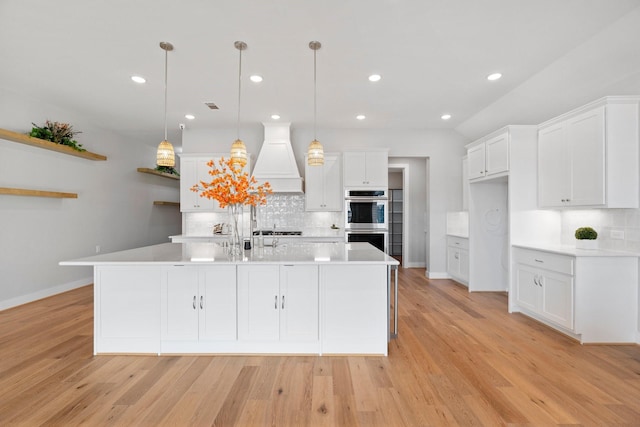 kitchen with open shelves, custom range hood, double oven, and white cabinetry