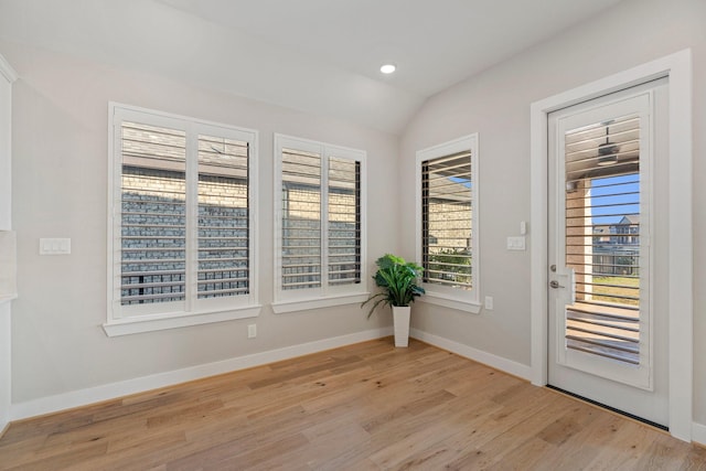 entryway with recessed lighting, baseboards, light wood-style floors, and vaulted ceiling