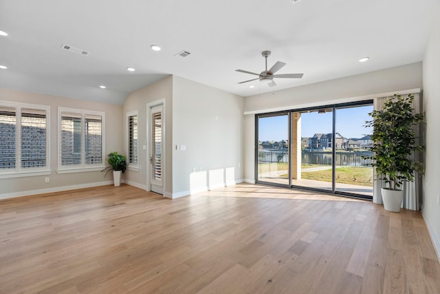 unfurnished living room featuring light wood-type flooring, visible vents, a ceiling fan, recessed lighting, and baseboards