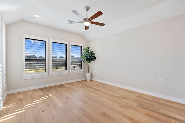 spare room featuring visible vents, light wood finished floors, ceiling fan, and vaulted ceiling