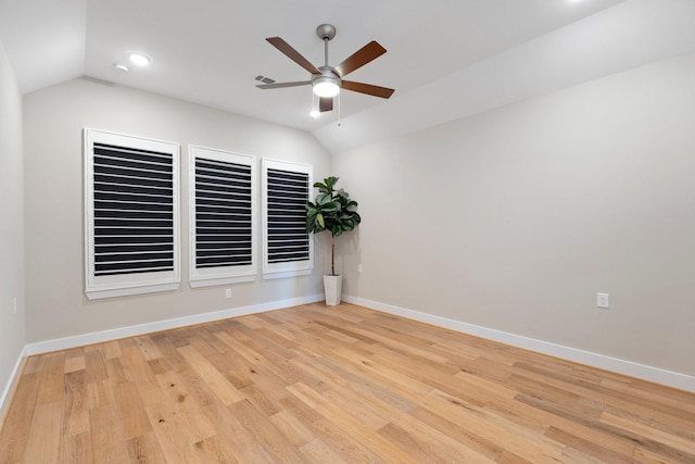 unfurnished room with vaulted ceiling, a ceiling fan, light wood-style floors, and baseboards