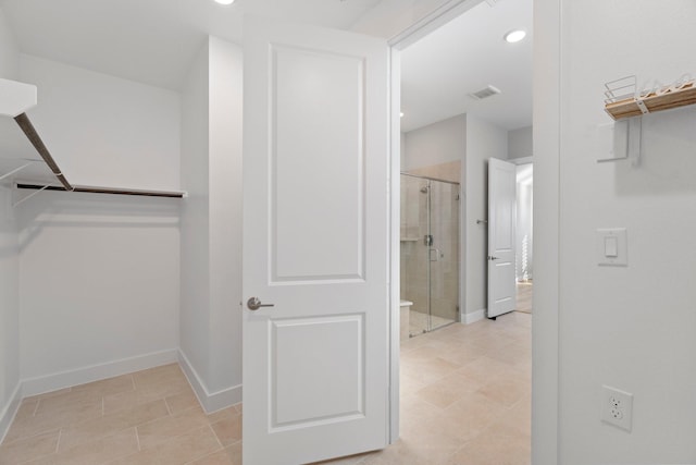 spacious closet with light tile patterned flooring and visible vents