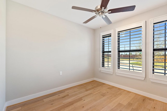 unfurnished room featuring baseboards, light wood-style floors, and a ceiling fan