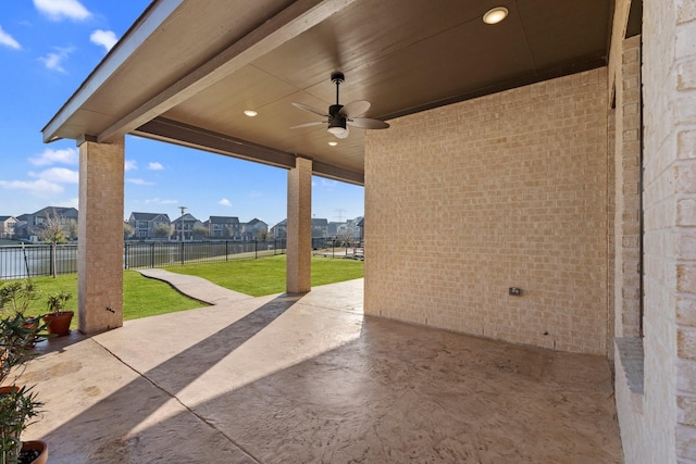 view of patio featuring a fenced backyard, a residential view, and a ceiling fan