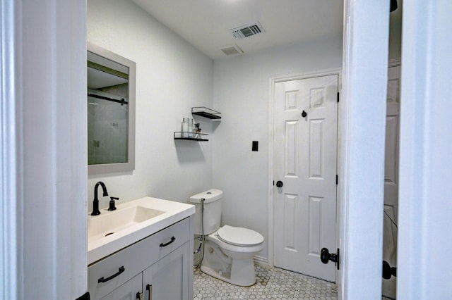 full bath featuring tile patterned floors, visible vents, toilet, vanity, and walk in shower