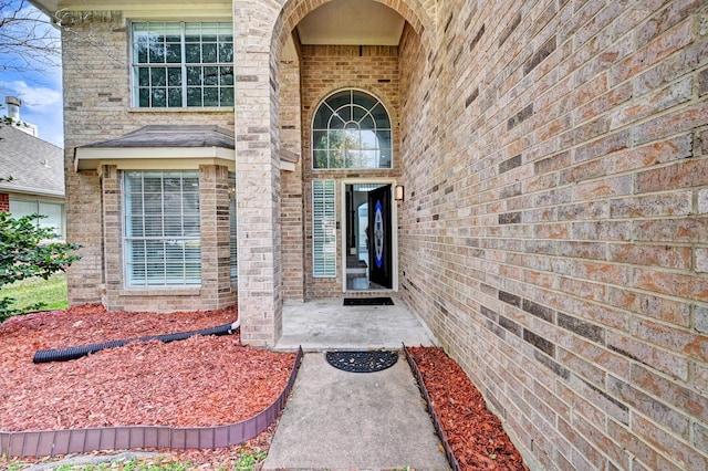 property entrance with brick siding