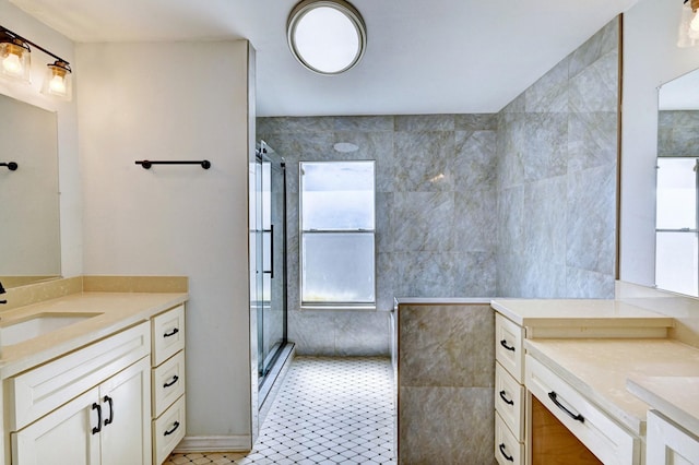 bathroom with two vanities, a sink, and a shower with shower door