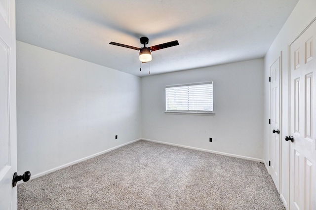 unfurnished bedroom with carpet, a closet, ceiling fan, and baseboards