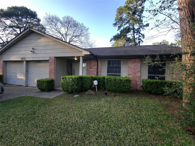 single story home with a front lawn, brick siding, an attached garage, and driveway