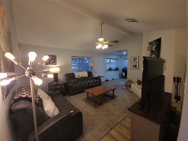 living area with lofted ceiling with beams, visible vents, wood finished floors, and a ceiling fan