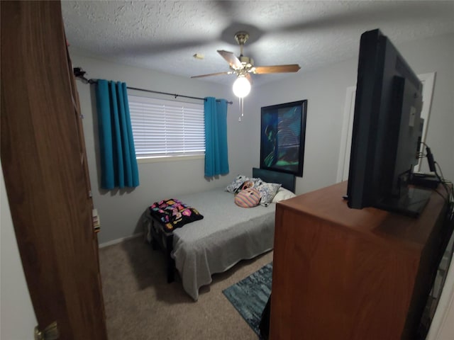 bedroom featuring a textured ceiling, ceiling fan, and carpet floors