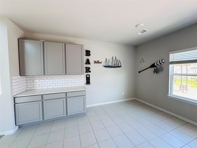 unfurnished room featuring visible vents, baseboards, and light tile patterned flooring