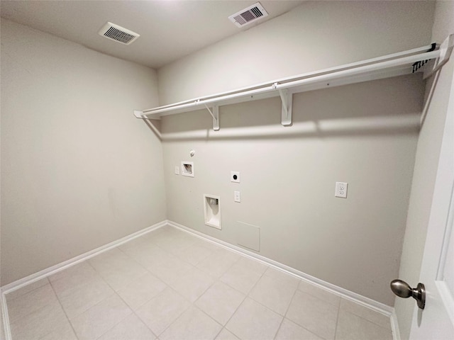 clothes washing area with laundry area, visible vents, gas dryer hookup, and electric dryer hookup