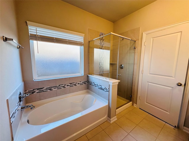 bathroom with a garden tub, a stall shower, and tile patterned flooring