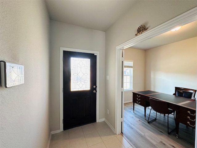 entrance foyer with light wood finished floors and baseboards