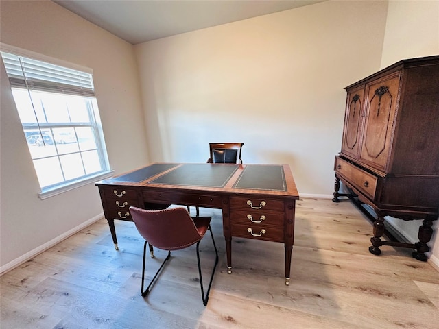 office space featuring light wood-type flooring and baseboards