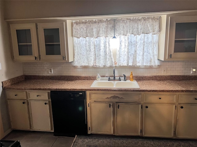 kitchen featuring tasteful backsplash, glass insert cabinets, dishwasher, and a sink